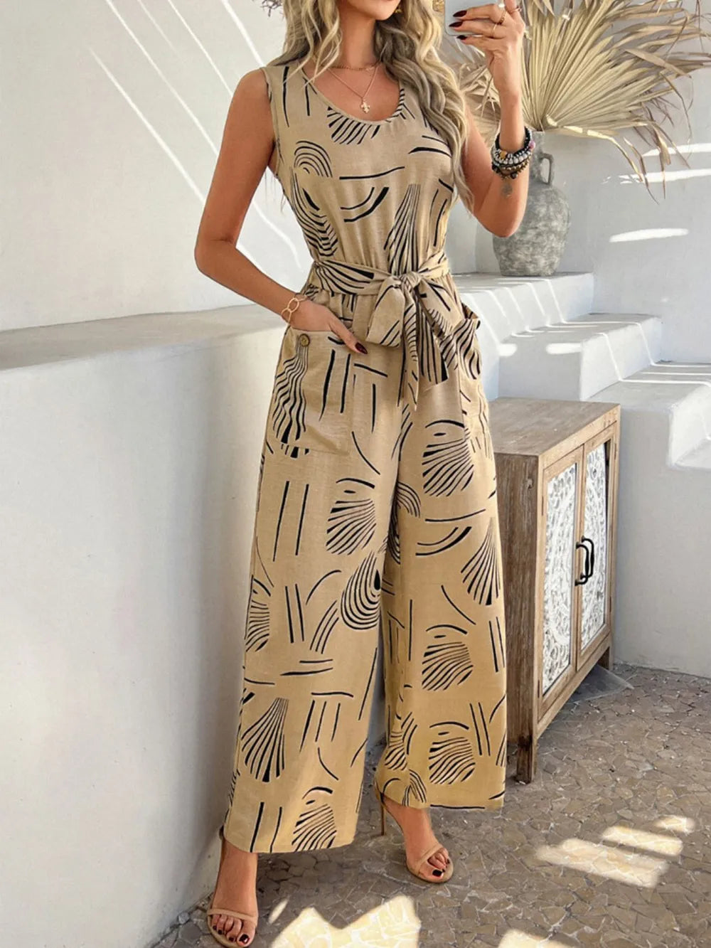 Devine Printed Round Neck Sleeveless Tie Waist Jumpsuit Tan